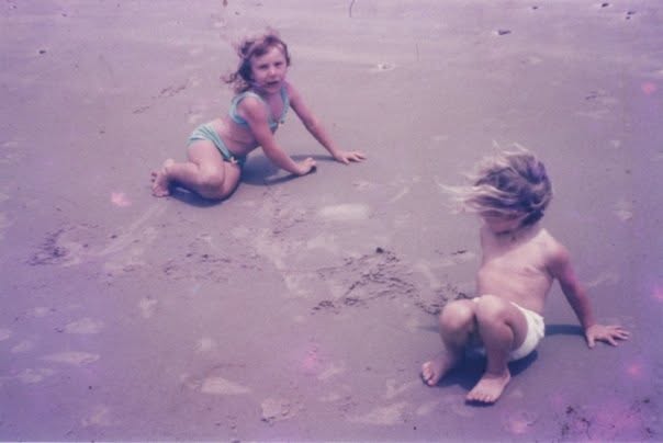 Anne as a little girl playing on the sand at the beach